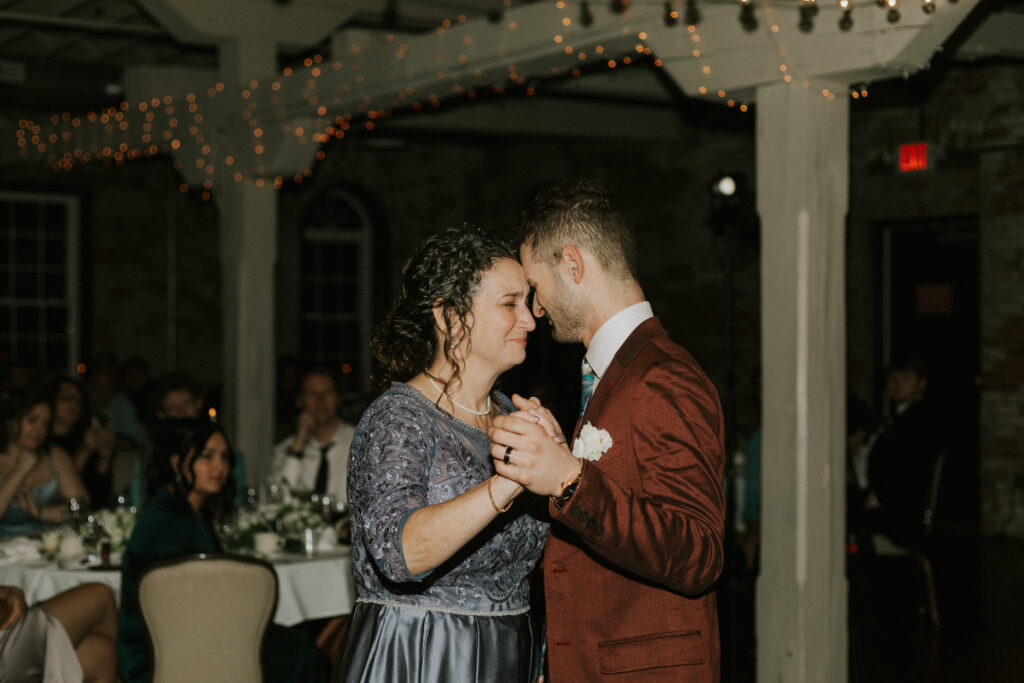 first dance of groom and mother of groom at wedding reception as they become emotional 