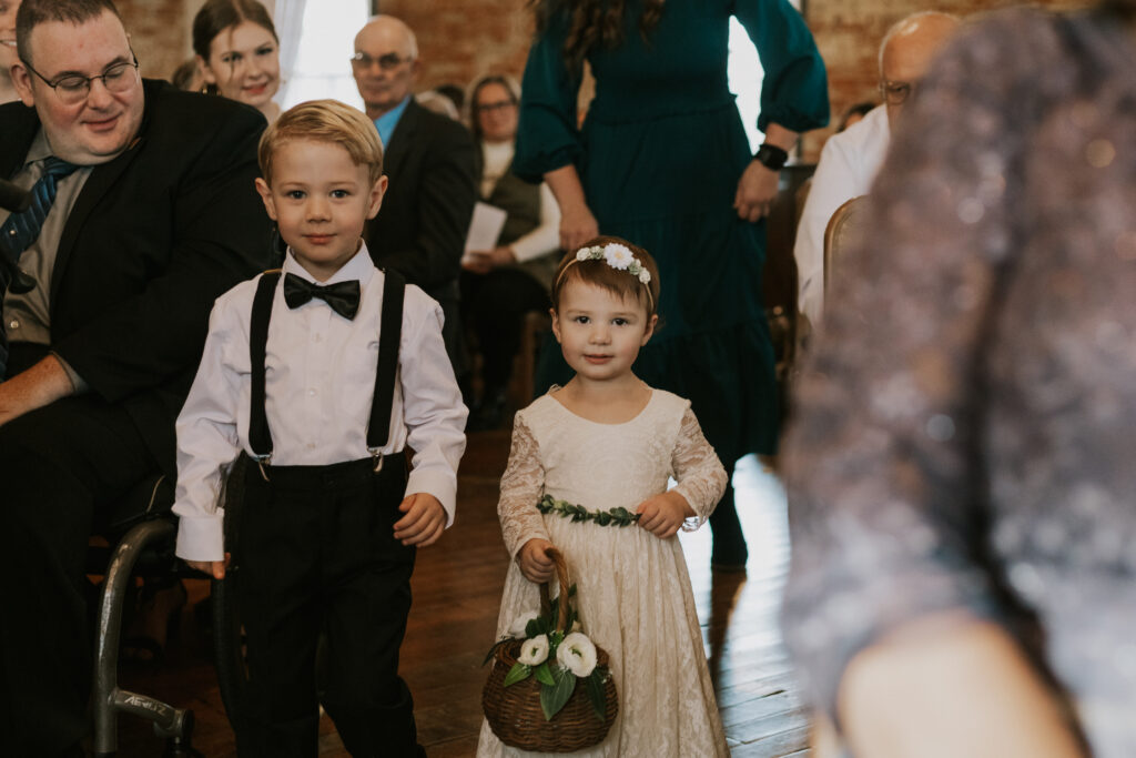 Wedding ceremony processional pictures at Goshen Indiana wedding venue at Bread & Chocolate, flower girl and ring bearer walking down aisle
