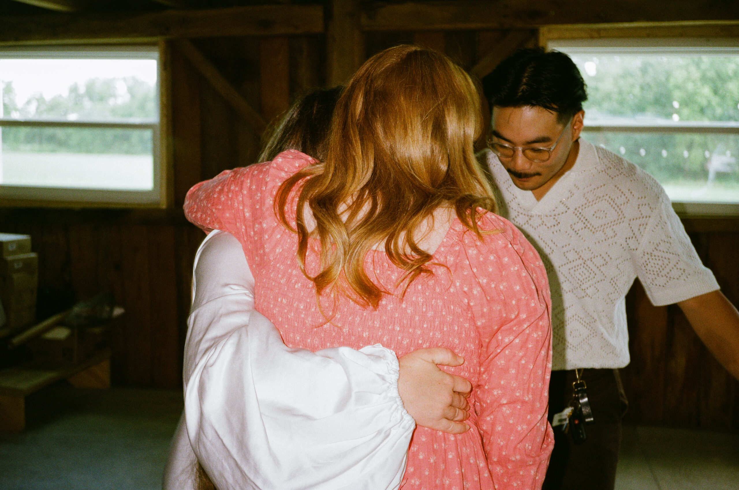 Guests hugging bride and groom at wedding reception in winona lake and warsaw indiana at an outdoor wedding.