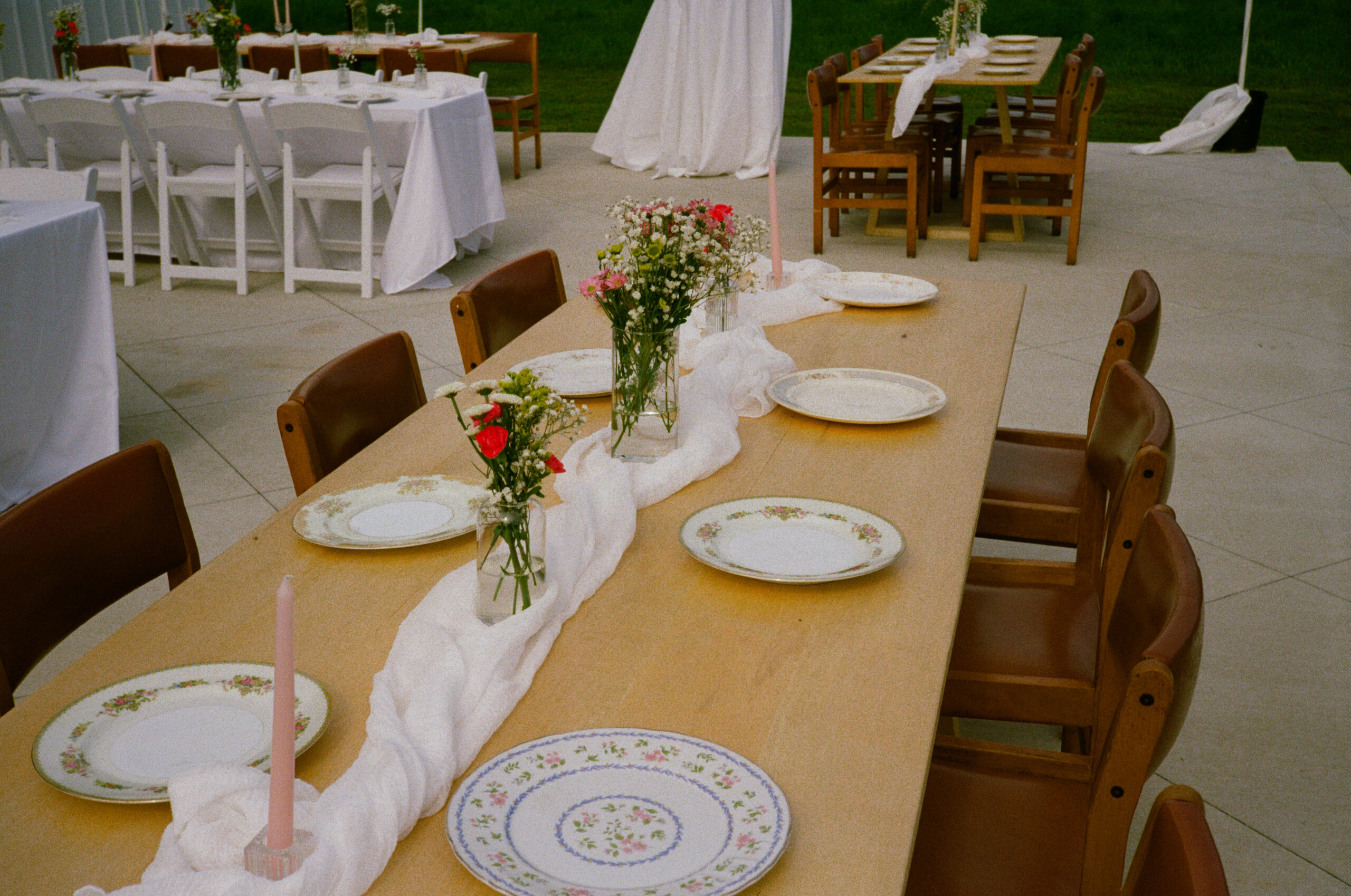 outdoor wedding reception details and decor, flower bud vases, mixed china plates, and tables in warsaw and winona lake indiana.