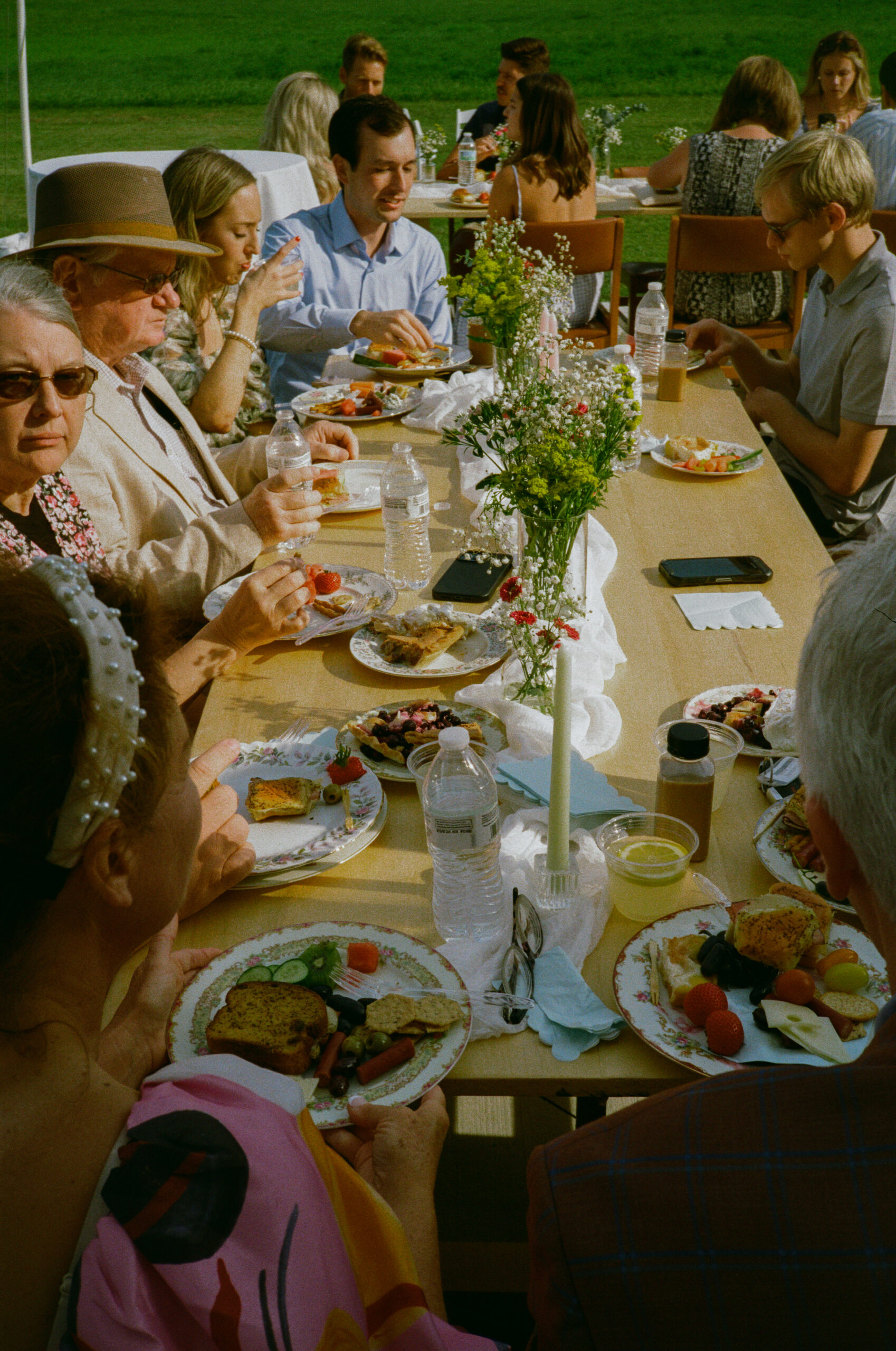 guests eating at outdoor wedding reception in warsaw and winona lake indiana, on 35mm film photography.