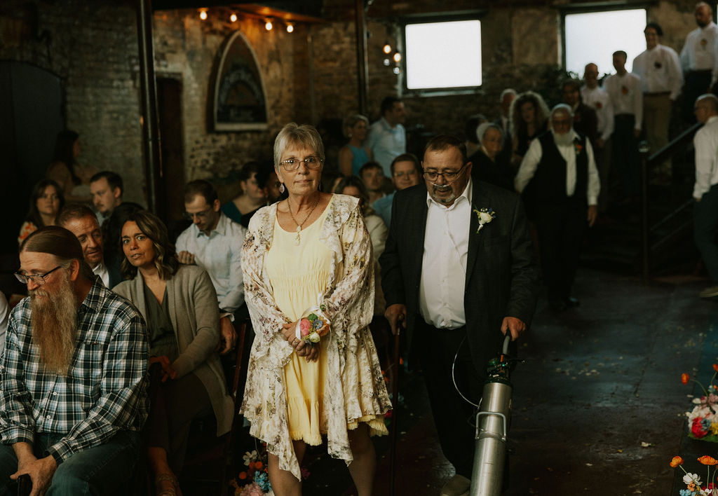 Grandparents walking down to aisle at wedding ceremony to take their seat at Muncie Indiana North Church Wedding Venue.