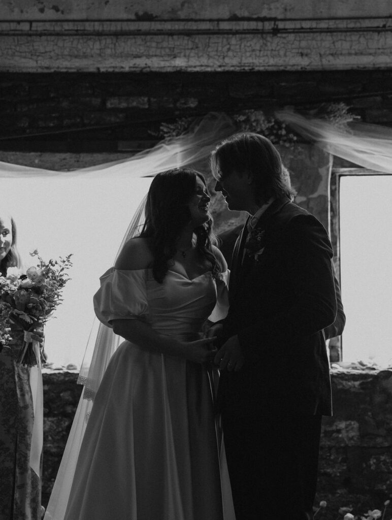 Bride and groom celebrate down the aisle after being declared husband and wife after wedding ceremony in Muncie, Indiana at North Church Venue.