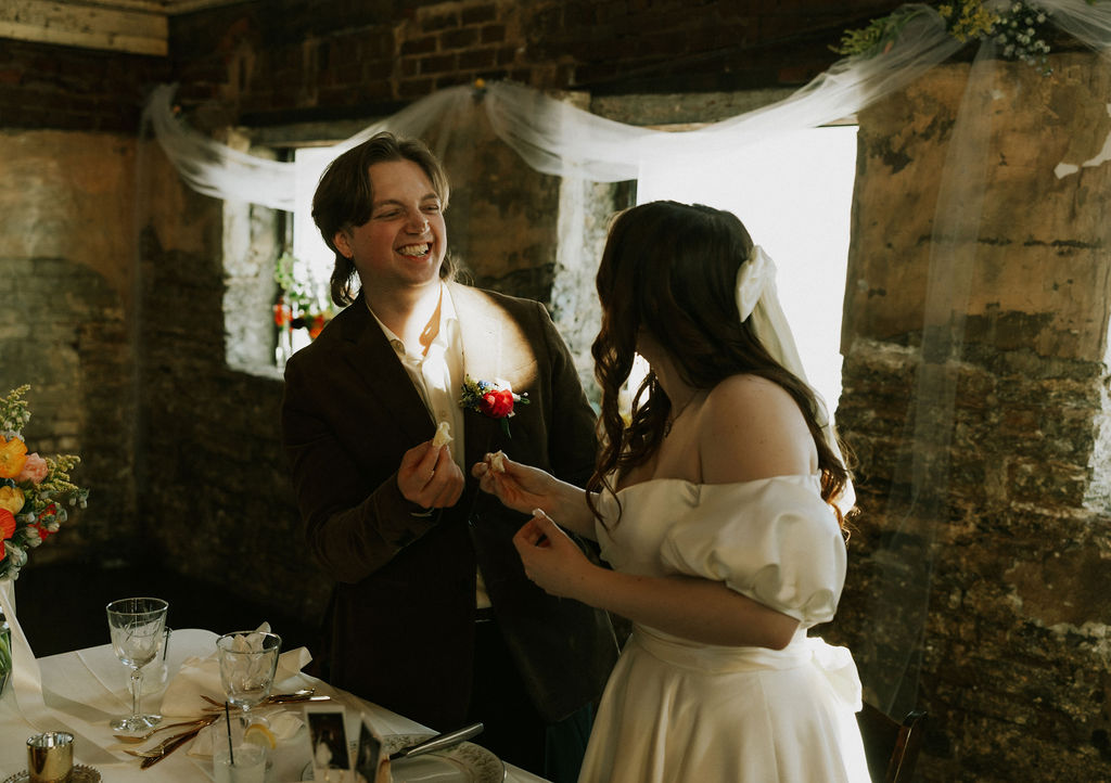 Bride and groom cake cutting at wedding reception in The North Church Wedding Venue in Muncie, Indiana