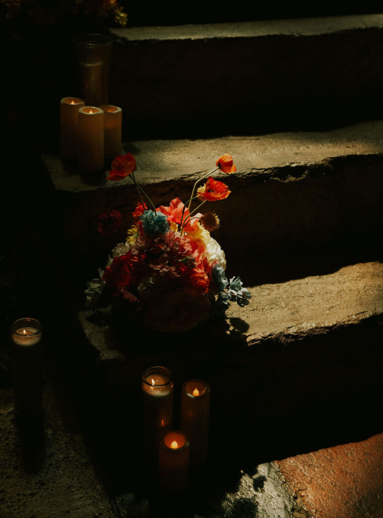 Eclectic wedding florals, colorful bouquets lining a historic stairway in The North Church venue in Muncie, Indiana.