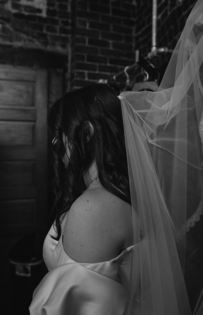 Bride getting ready and putting on veil on her wedding day at The North Church Venue in Muncie, Indiana.