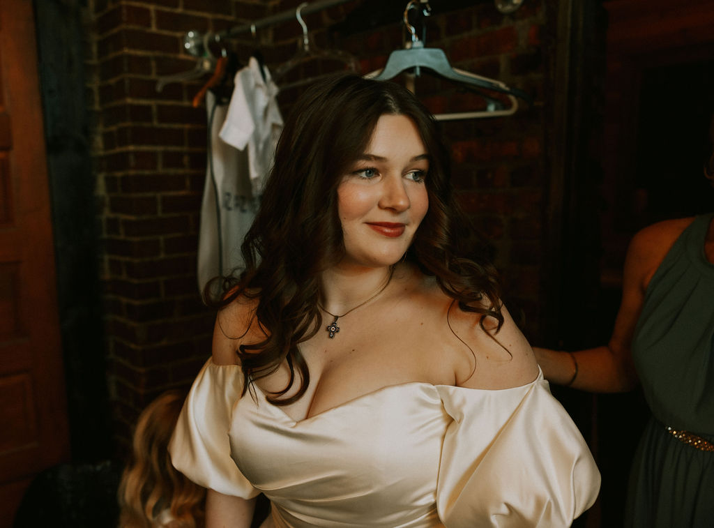 Bride getting ready and putting on veil on her wedding day at The North Church Venue in Muncie, Indiana.