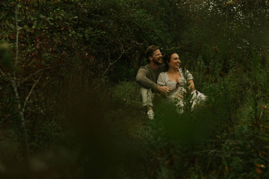 Couple getting engaged and taking couple photos on Mackinac Island, Michigan on the beach.