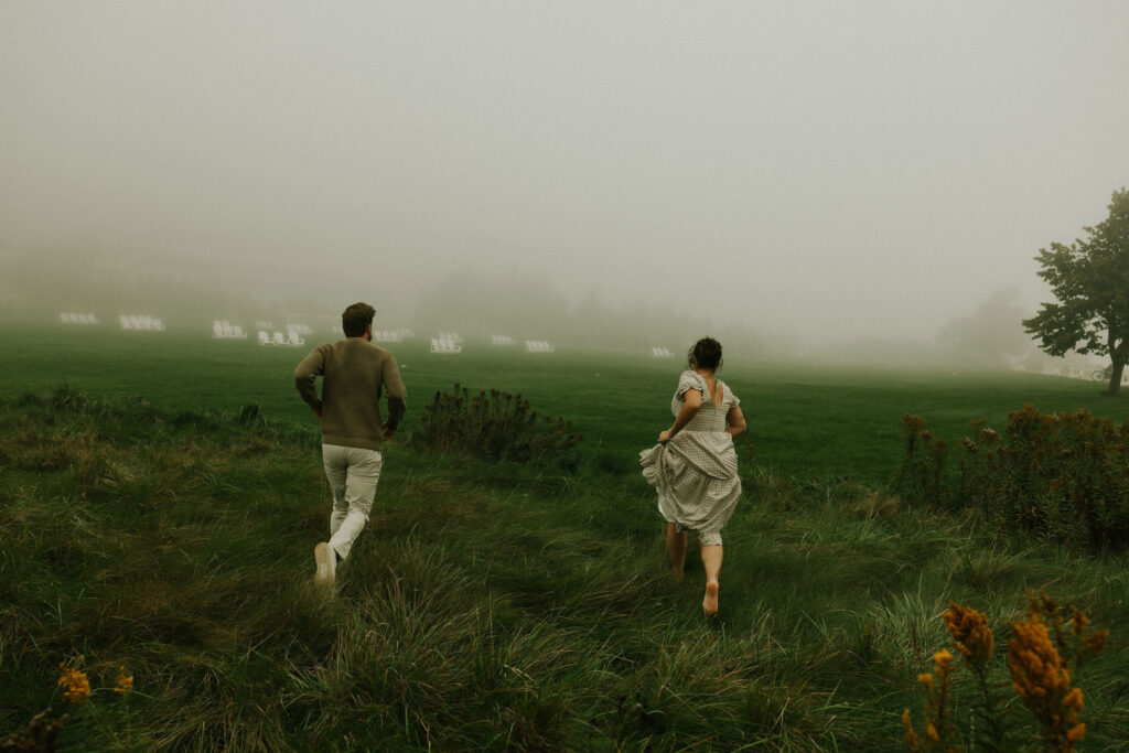 Couple getting engaged and taking couple photos on Mackinac Island, Michigan on the beach.