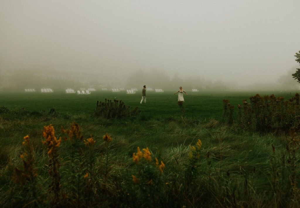 Couple getting engaged and running together on Mackinac Island, Michigan.