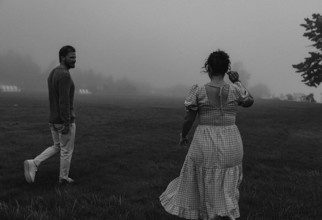 Couple getting engaged and taking couple photos on Mackinac Island, Michigan on the beach.