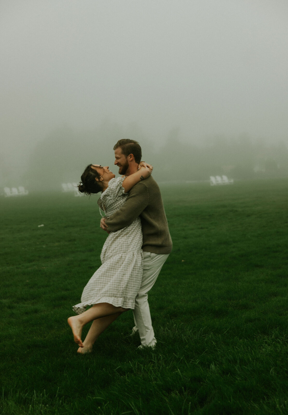 Couple getting engaged and taking couple photos on Mackinac Island, Michigan on the beach.