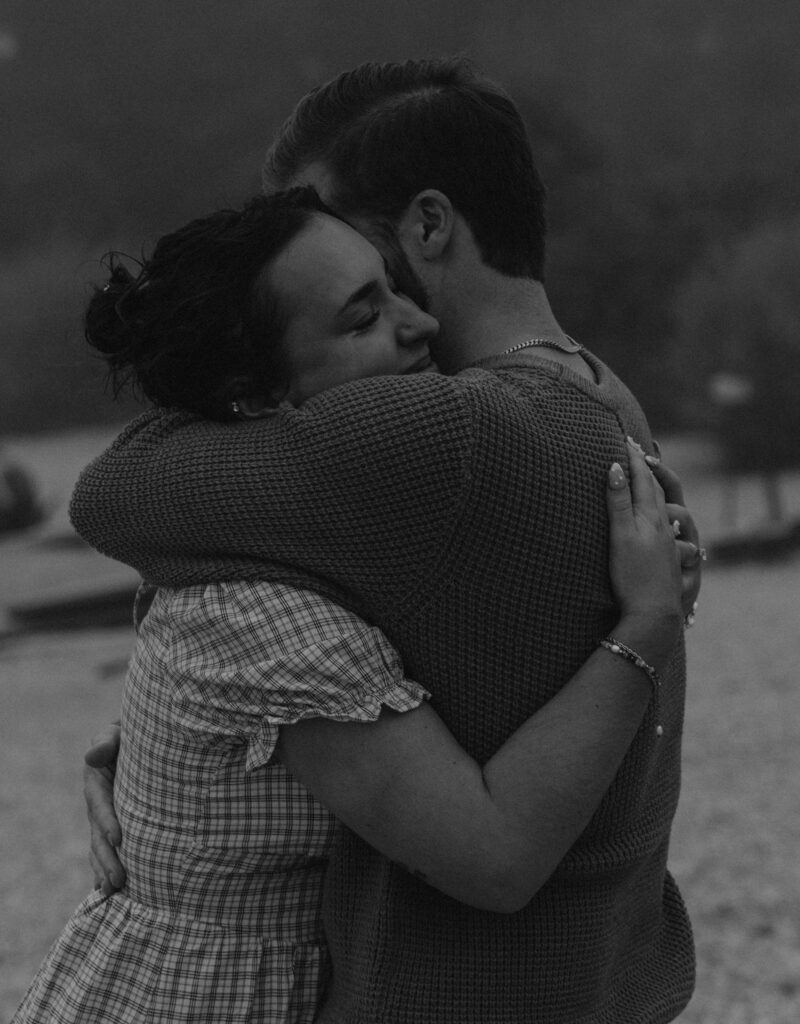 Couple getting engaged on Mackinac Island, Michigan on the beach.