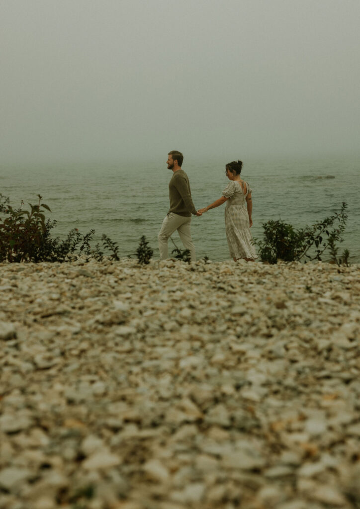 Couple getting engaged on Mackinac Island, Michigan on the beach.