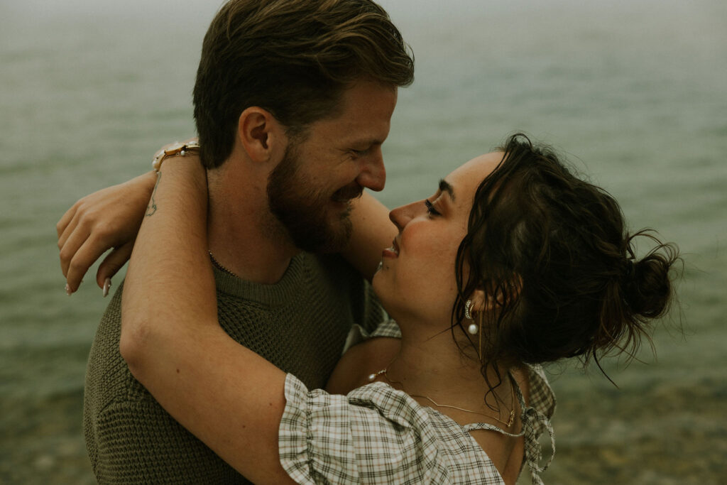 Couple getting engaged on Mackinac Island, Michigan on the beach.