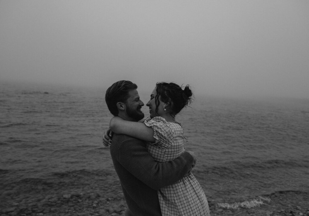 Couple getting engaged on Mackinac Island, Michigan on the beach.