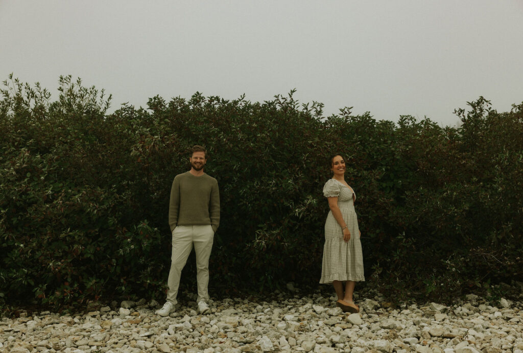 Couple getting engaged on Mackinac Island, Michigan on the beach.