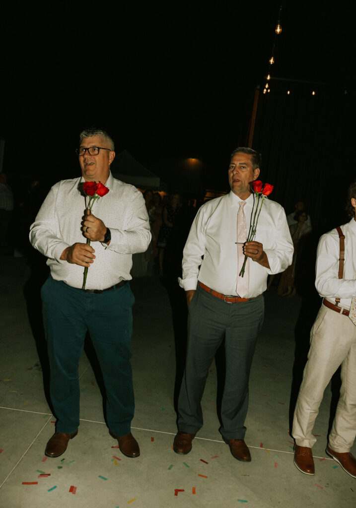 Wedding guests playing a wedding game during the reception, with roses.