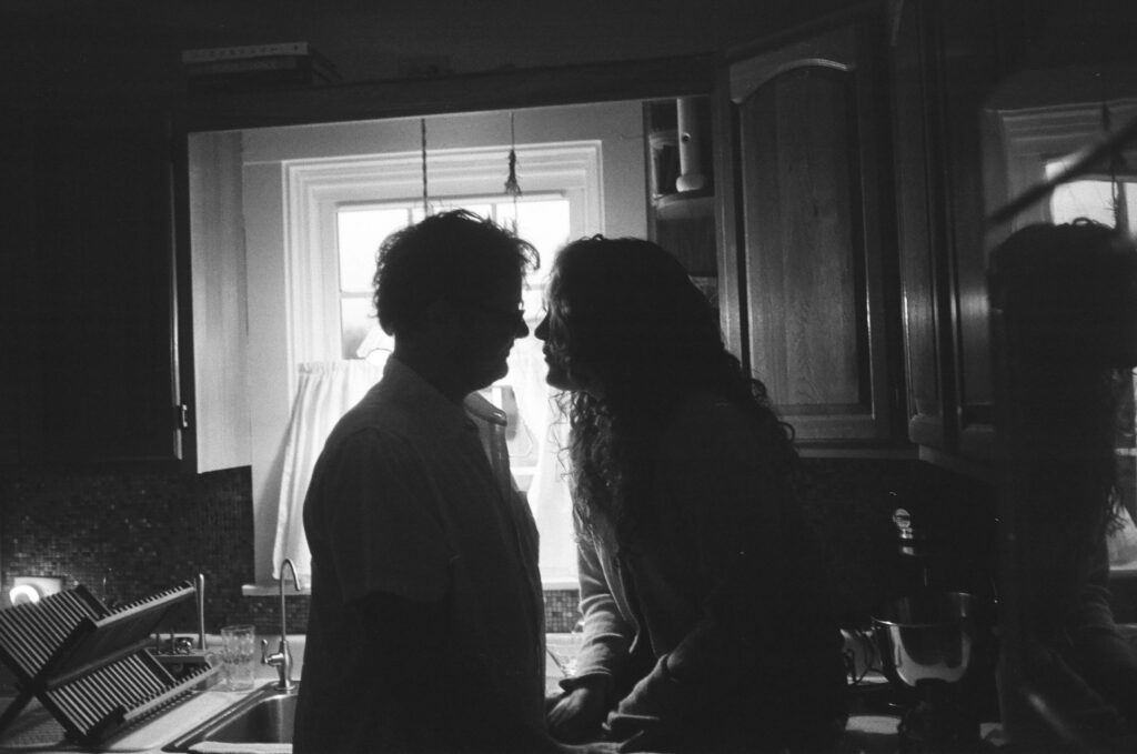 Black and white 35mm film image, couple at home in the kitchen Indiana film photographer.