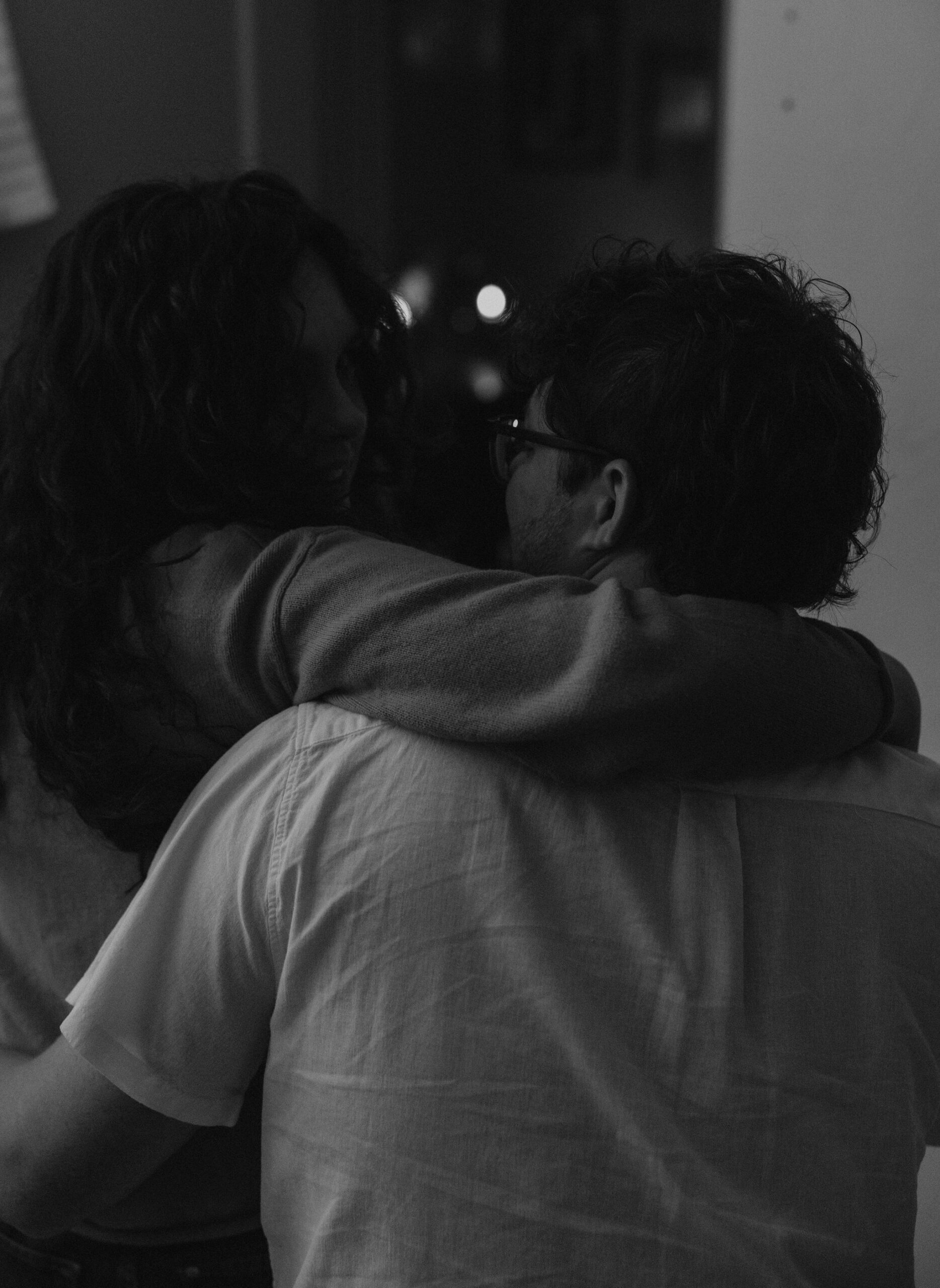 Couple cuddled on the couch together in their living room.