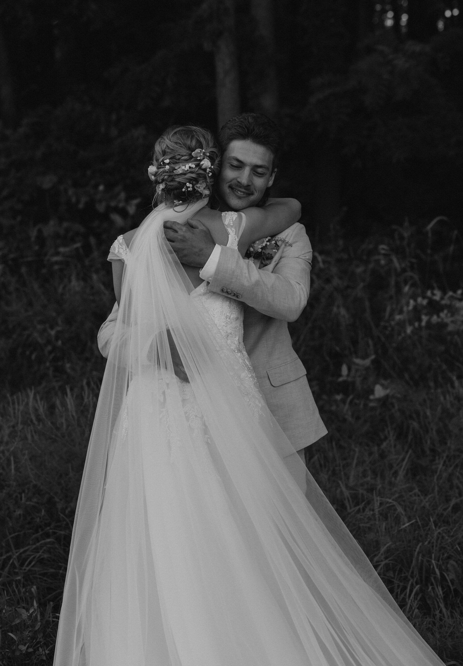 Bride and Groom exchange a tight hug after their first look/