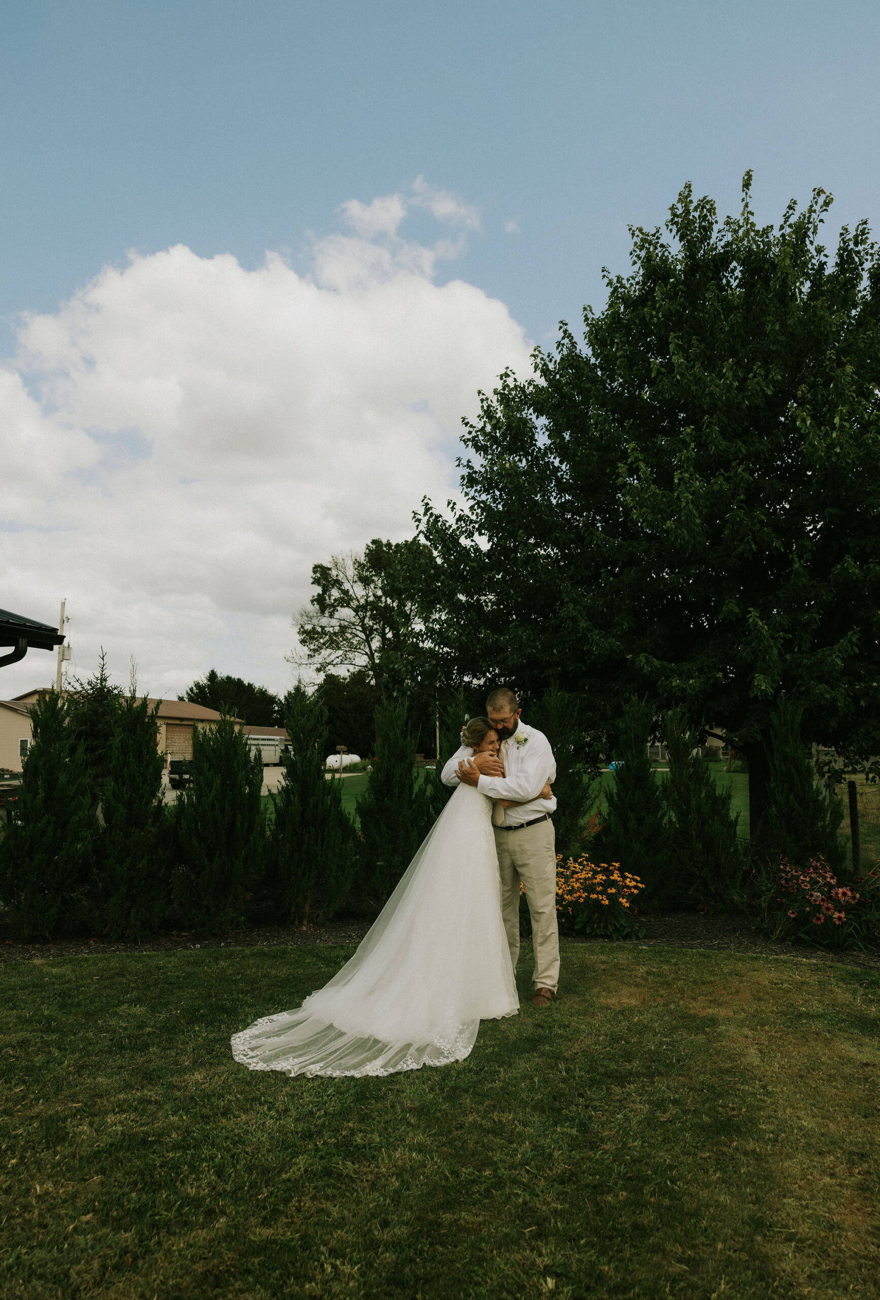 Bride and Bride's dad share a special first look together and hug.