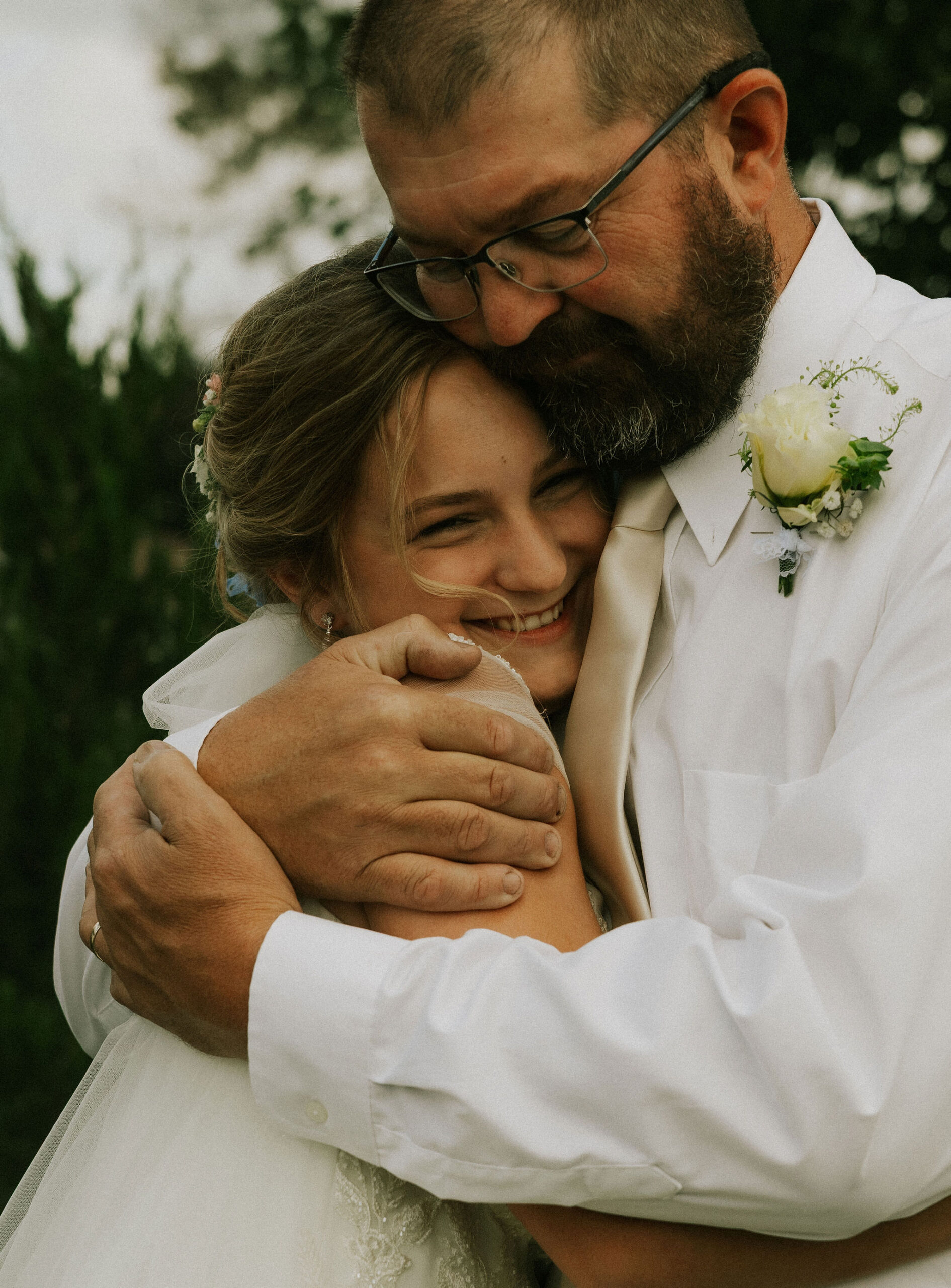 Bride and Bride's dad share a special first look together and hug.