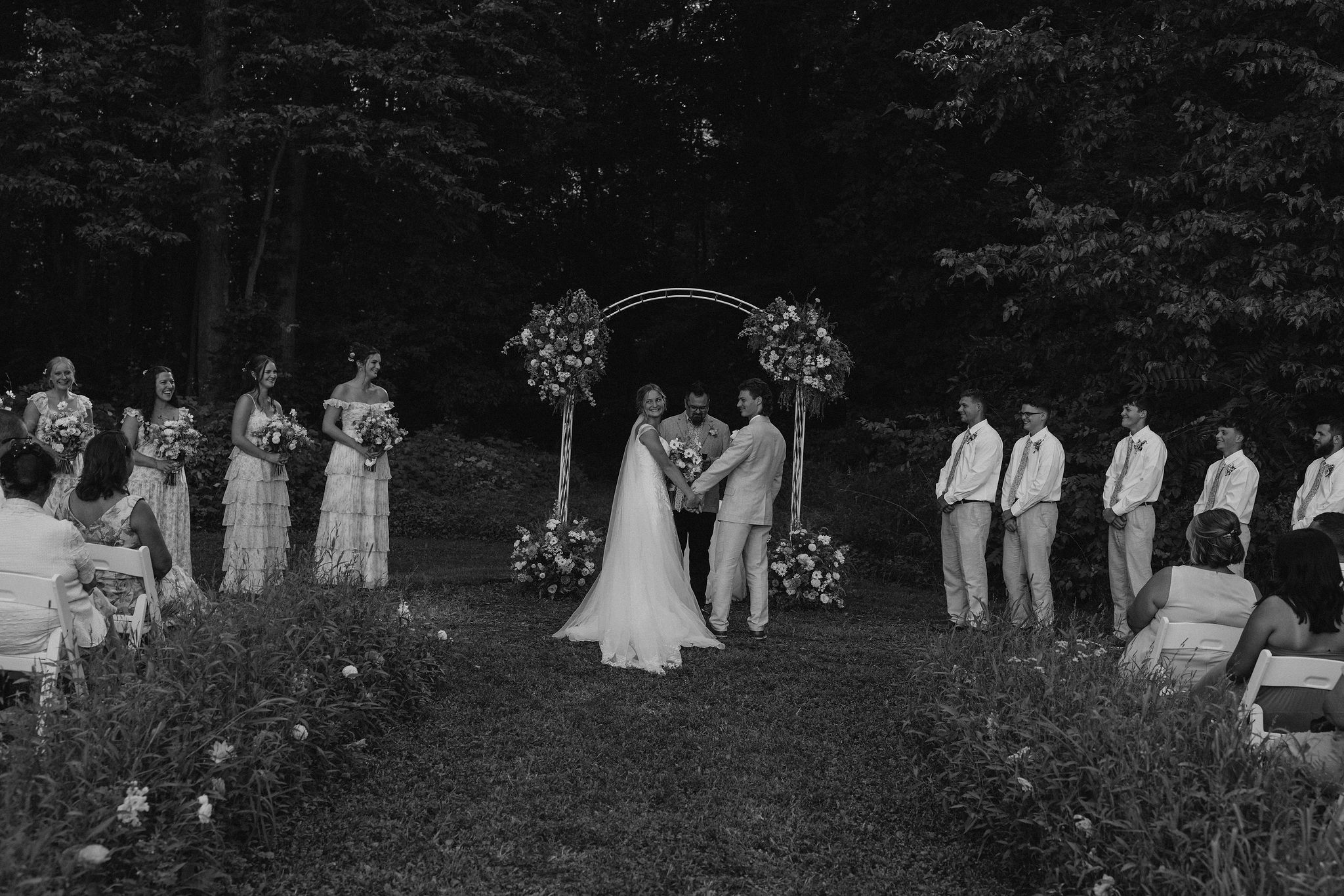 Bride and groom look back at their guests at the ceremony.