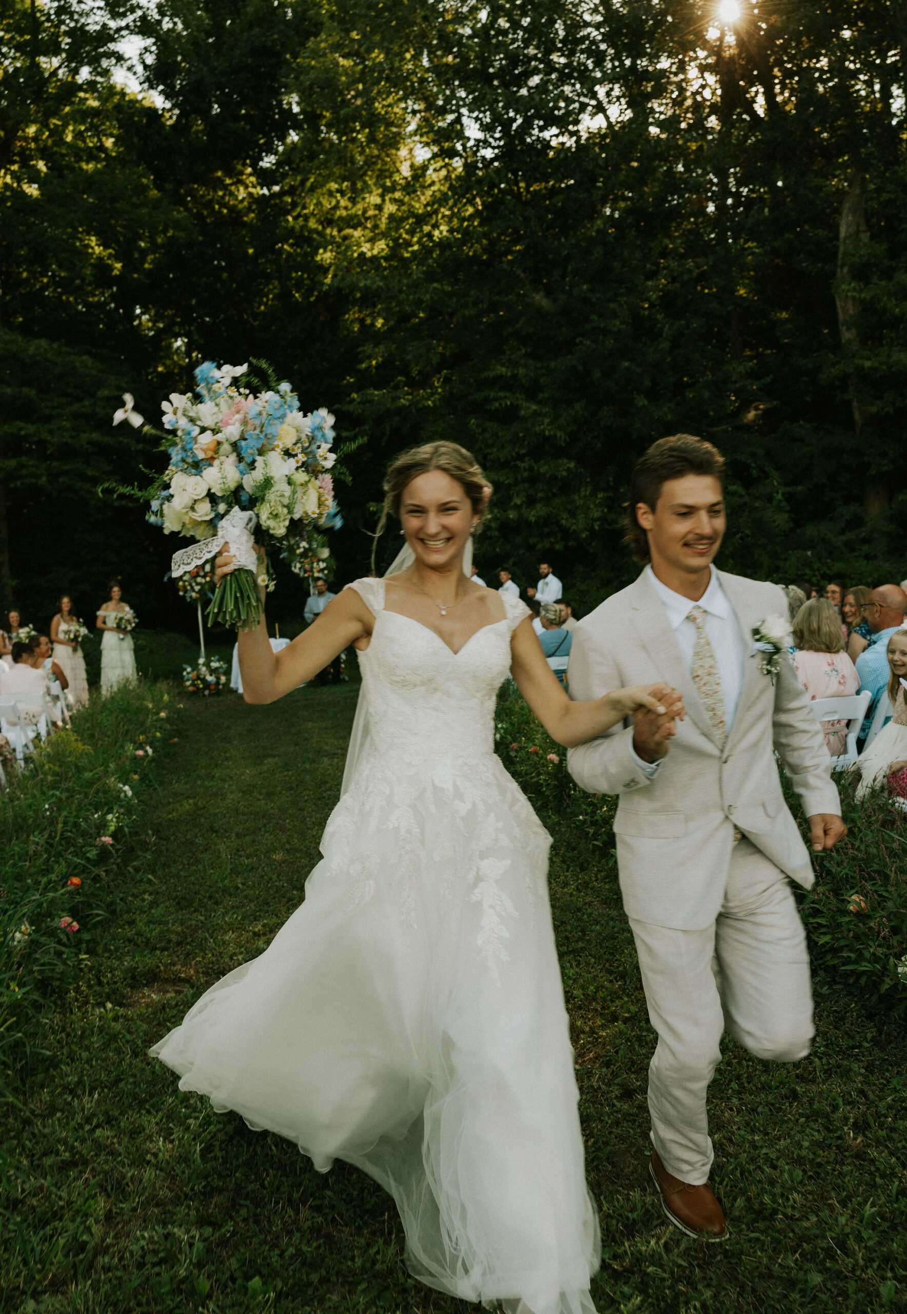 Bride and groom run down the aisle together after being called husband and wife.