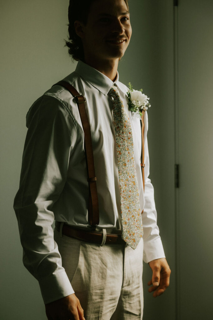 The groom in his outfit as he gets ready for the wedding day.