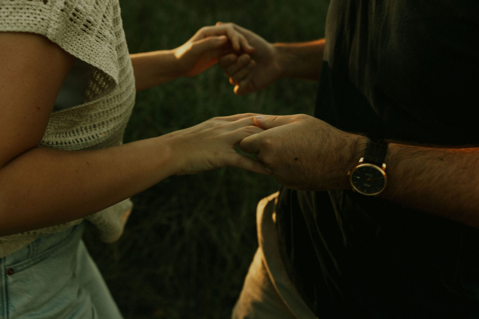 Engaged couple holding hands at Warren Dunes State Park.