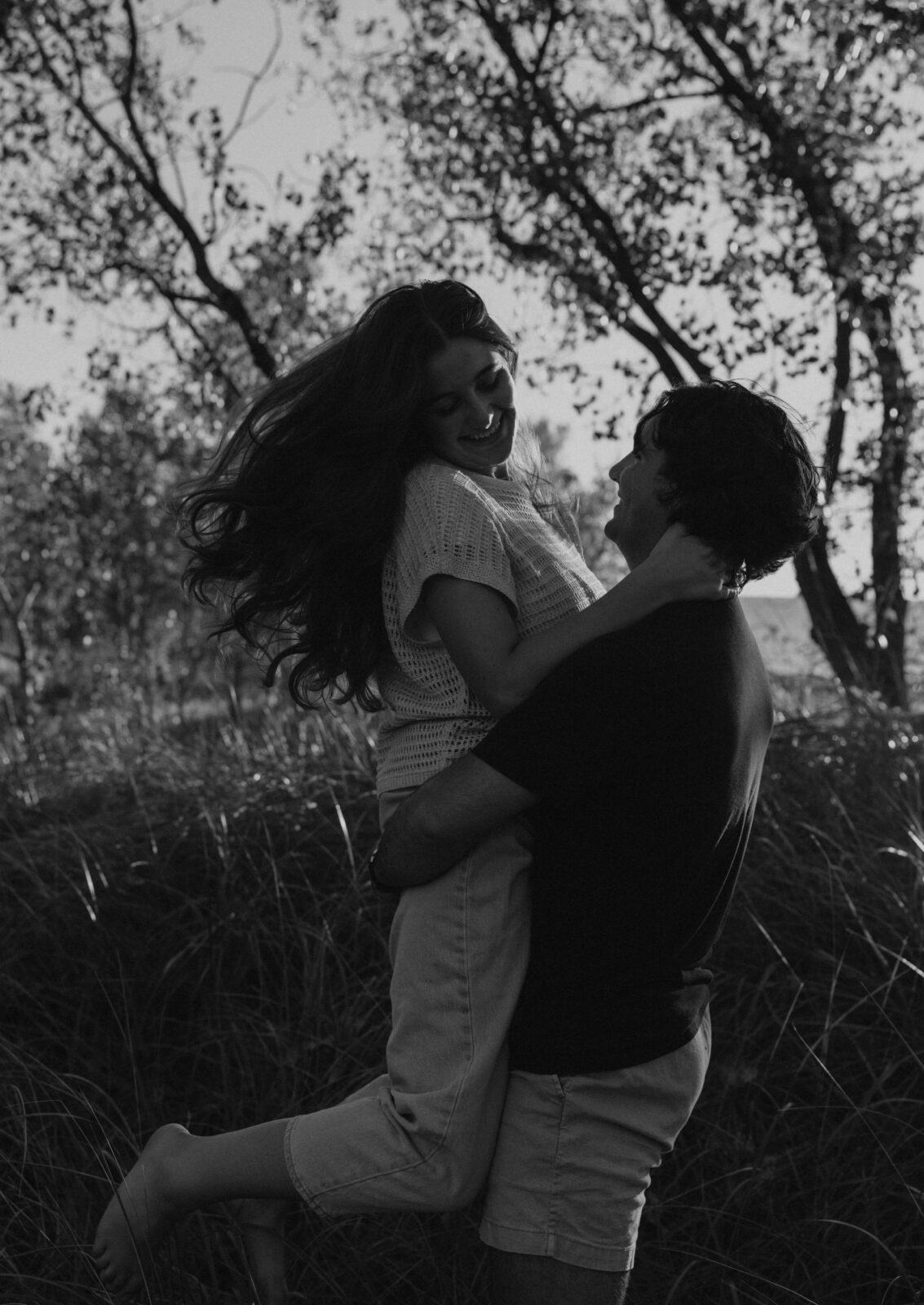 Engaged couple picking up girl at Warren Dunes State Park.