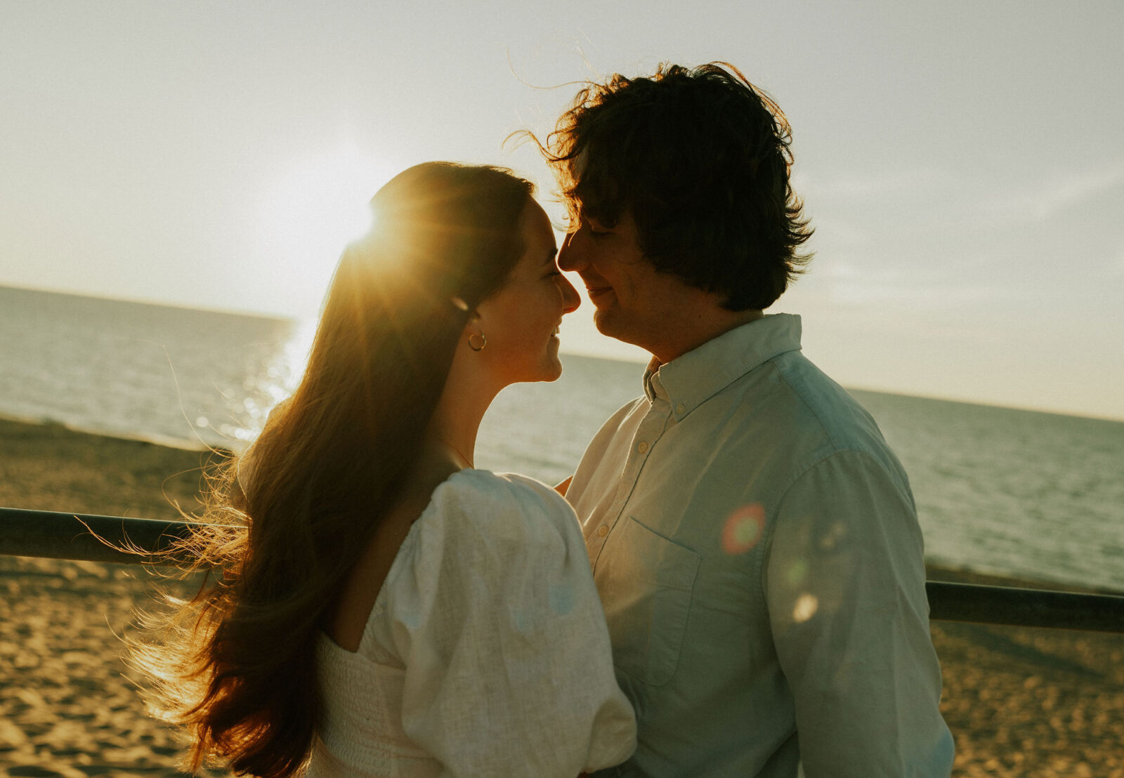 Engaged couple holding each other at Warren Dunes State Park.