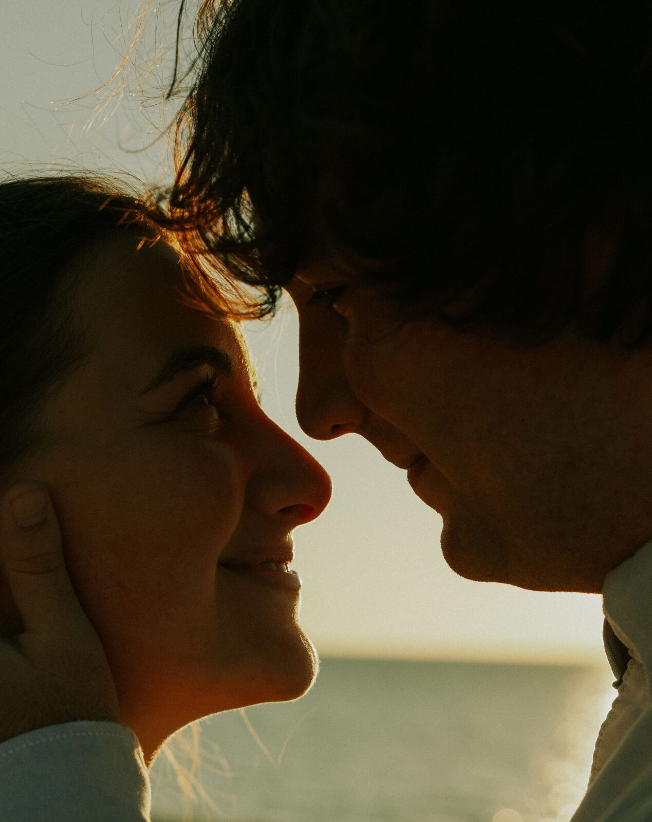 Engaged couple looking into each other's eyes at Warren Dunes State Park.