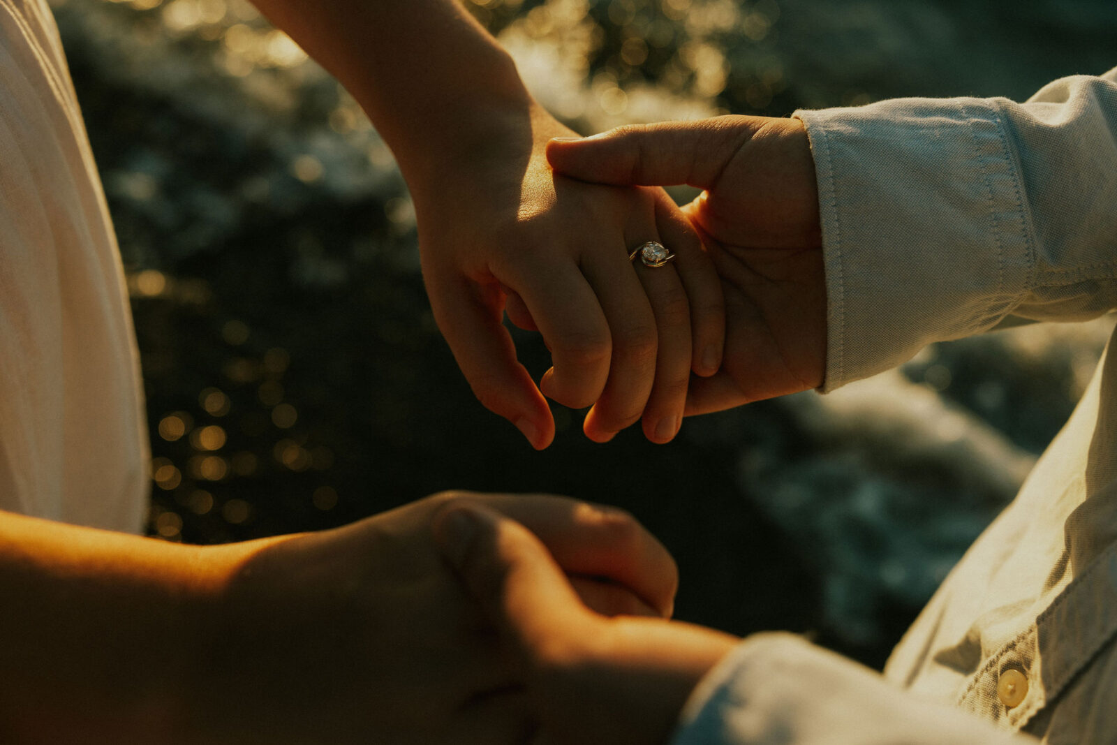 Closeup of engagement ring on beach in Warren Dunes State Park.