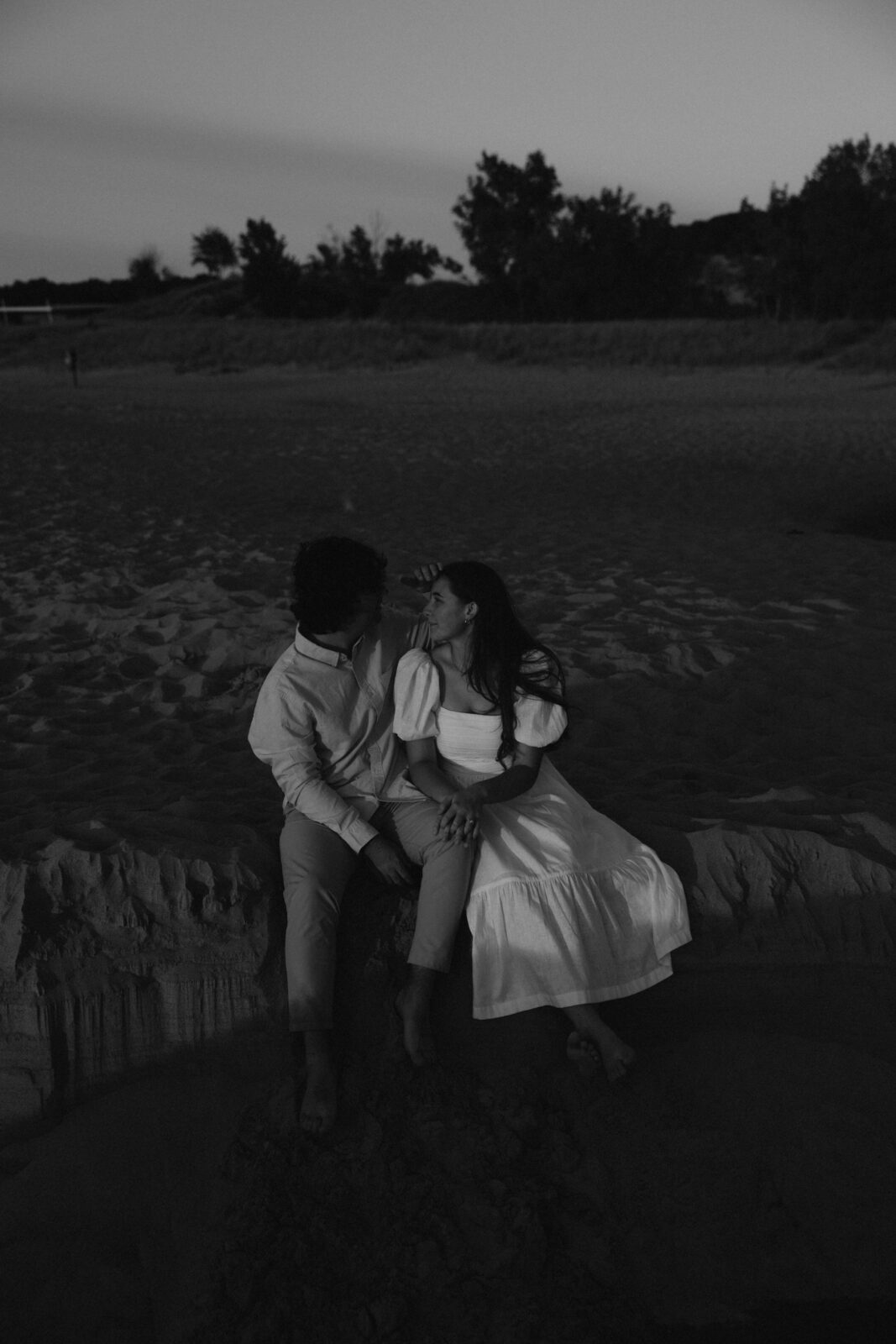Couple sitting on dune at Warren Dunes State Park.